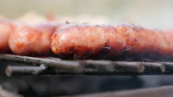 Smoke spreading over  sausages on the barbecue 4K 2160p 30fps UltraHD footage - Moutwatering juicy s