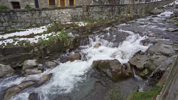 Black River in Slow Motion at His Pass Through the Pretty Town of Vielha