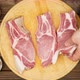 The cook prepares pieces of meat on a cutting board on a wooden table. A man's hand lays out a pork - VideoHive Item for Sale
