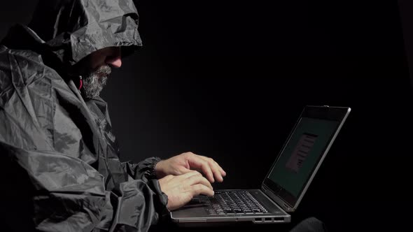 Computer Hacker Stealing Data From A Laptop