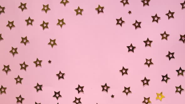 Golden Stars Confetti on Pink Background