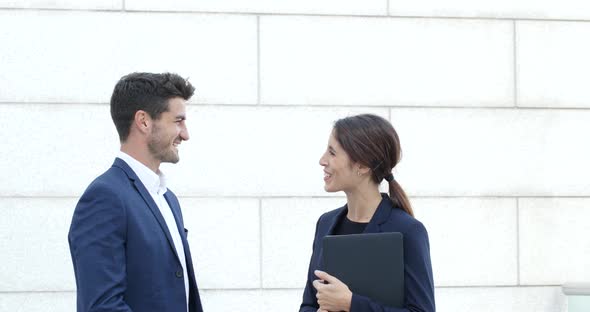 Business man and woman discuss the project outside office