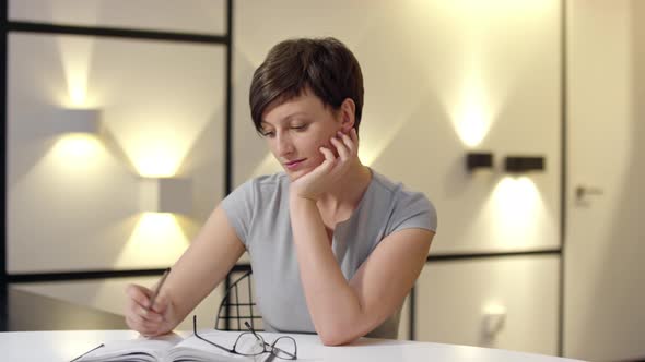 Woman Writing Ideas in Organizer