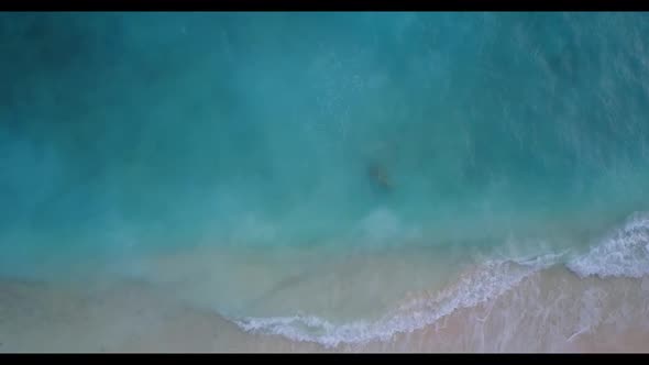 Aerial drone shot landscape of tropical seashore beach holiday by shallow sea and white sand backgro