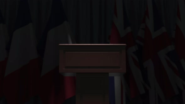Many Flags of Great Britain and France Behind Speaker Tribune alt