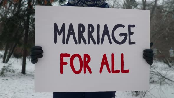 Activist Supports LGBT Rights Equality By Demonstrating Marriage For All Placard