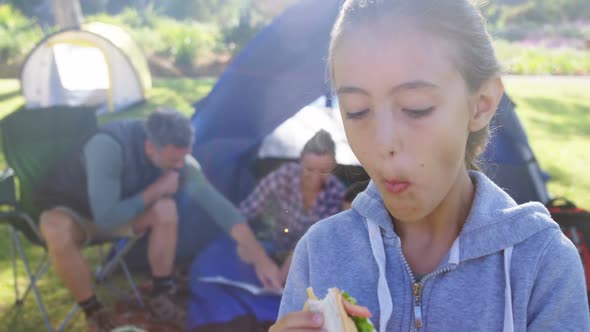 Girl having sandwich in picnic at park