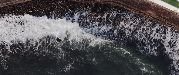 Top view of the wavy sea at the shoreline