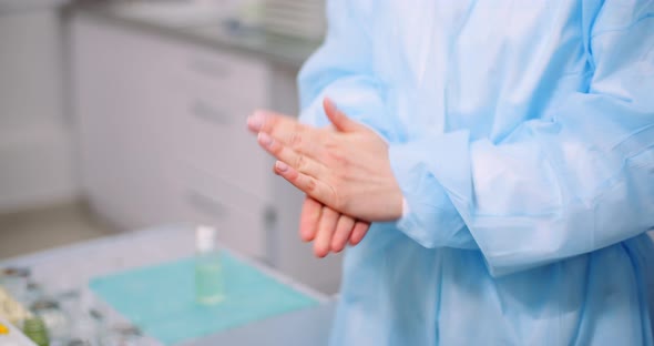 Doctor Disinfecting Hands with Bactericidal Gel