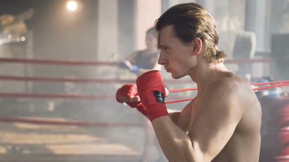 Confident Young Man Training in the Boxing Club