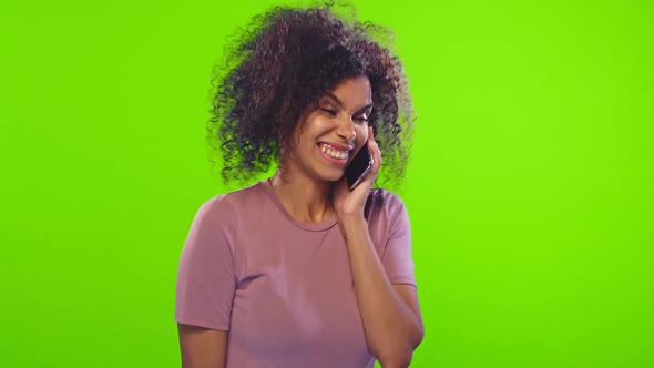 Happy Hipster Dark-skinned Girl Talking on Mobile Phone, Receiving Good News