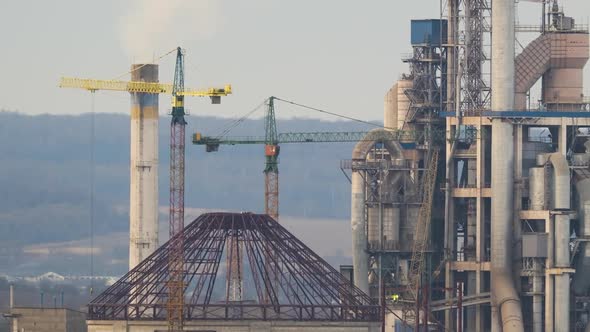 Timelapse of Cement Plant with High Factory Structure and Tower Cranes at Industrial Production Area