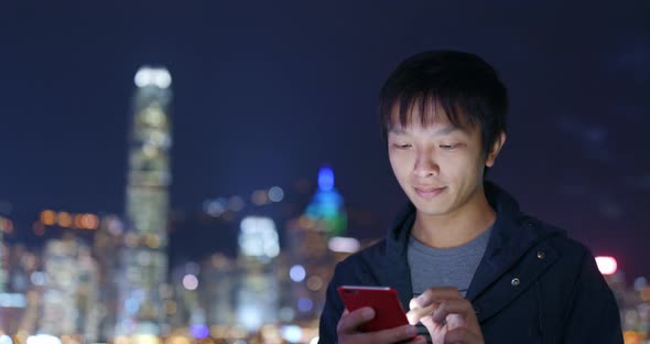 Man Use of Mobile Phone in City at Night