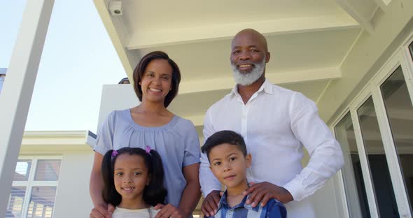 Low angle view back family standing on porch and looking at camera in a comfortable home 4k