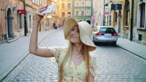 Attractive Young Lady Posing for Selfie and Standing on City Square