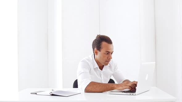 Young Businessman Smiling Typing on Laptop Showing Okay at Workplace Slow Motion