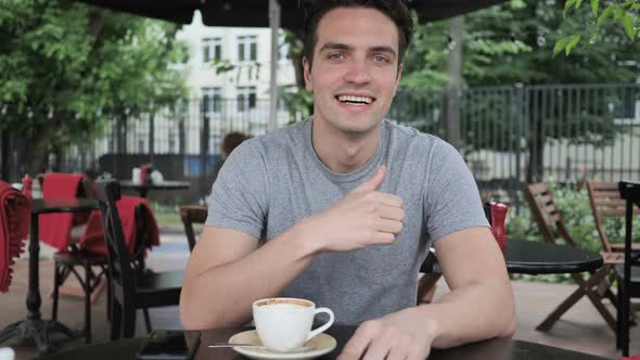 Thumbs Up By Man Sitting in Cafe Terrace Window