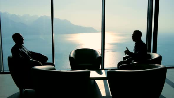 Two Young Business People Having a Meeting in Modern Lobby Hall