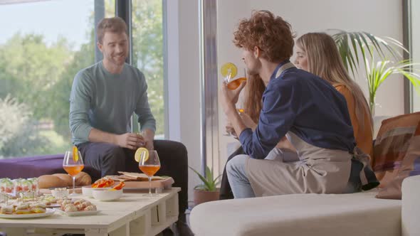 Four Friends Happy Talking Eating and Drinking Cocktail