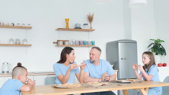 Happy American Family Eating Pizza at Home