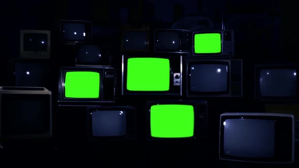 Retro TV Wall, Four Old Televisions Turning On Green Screens. Dark Tone. Zoom In.