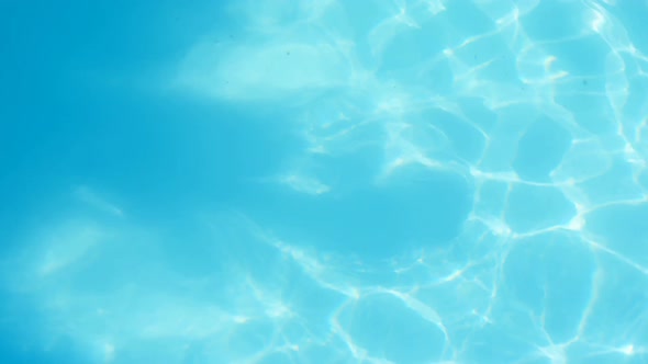 High angle view of young mixed-race woman swimming underwater in the swimming pool 4k