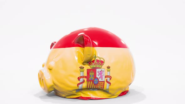 Deflating Piggy Bank with Flag of Spain