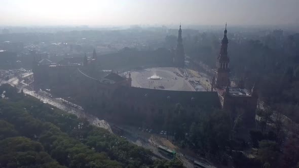 Drone flying towards Plaza de España in Sevilla Spain on a hazy morning