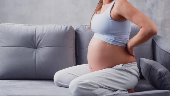 Young pregnant woman is resting at home and expecting a baby.