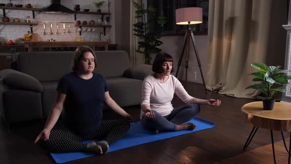 Calm Disabled Girl with Mom Practicing Yoga Indoor