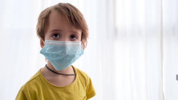 Portrait of a Child in a Medical Protective Mask