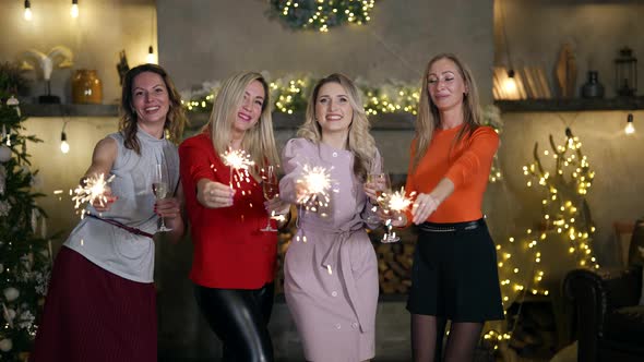 New Year Party Women are Celebrating Christmas Waving Burning Sparklers