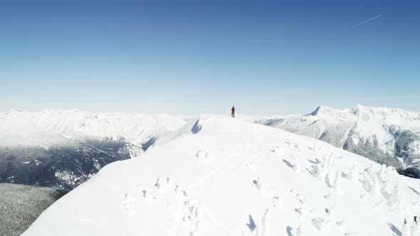 Skier standing on the top of snow capped mountain 4k