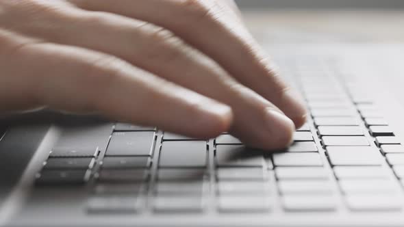 Closeup of Male Hands on a Laptop Keyboard