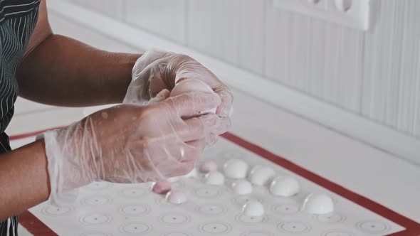 Woman Chef Smoothing Out the Edges of a White Cream Molds