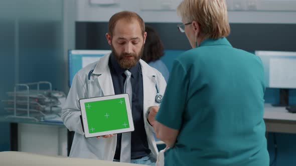 Health Specialist Showing Tablet with Horizontal Green Screen