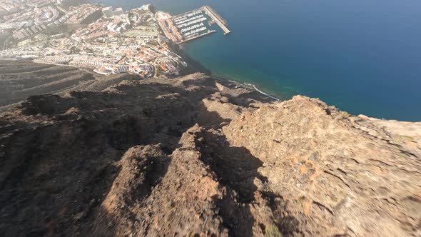 FPV Aerial Clip of Steep Rocky Rough Cliff Diving Flying Along Rocks Stones and Boulders in a Rugged