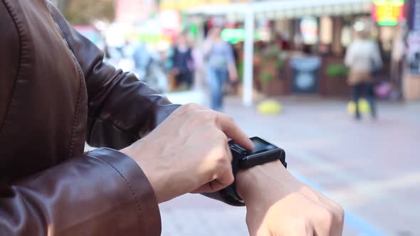 Girl Using A Smart Watch In The Street During The Day