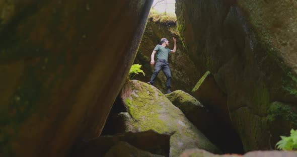 The tourist in the mountain gorge The Krasnoyarsk Pillars