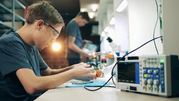 Male Specialist is Repairing a Mobile Phone