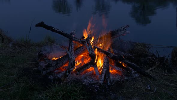 Campfire near water. Evening near River, Lake Camping place	