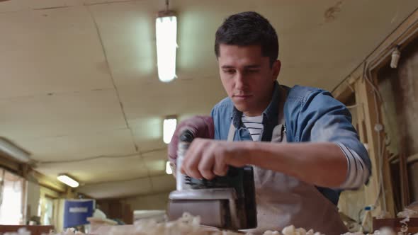 Woodworker Grinding Plank alt