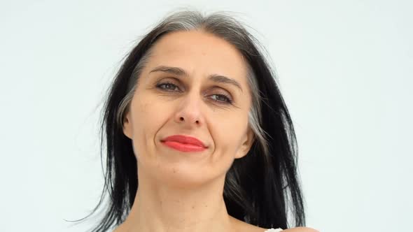 Female Portrait of Middle Aged Woman Starting Getting Greyhaired in Studio with Naked Shoulders on