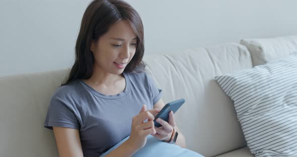 Young woman use of mobile phone at home