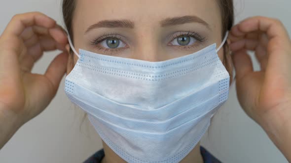 Woman wearing protective medical face mask for for virus infection prevention and protection.
