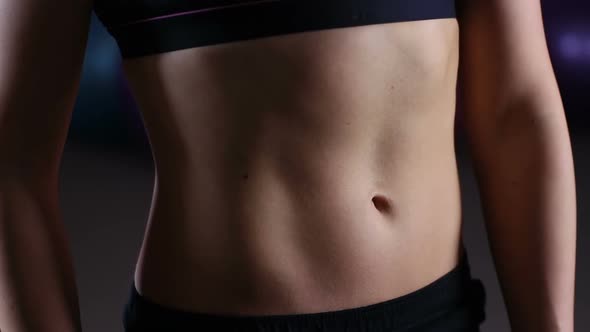 Flat Tummy of Active Woman With Sportive Body Breathing Heavily After Workout