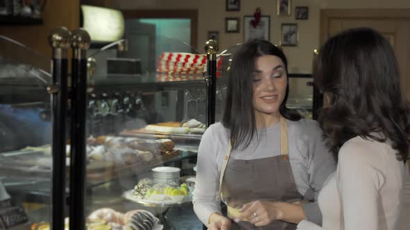 Lovely Young Woman Talking To a Customer at Her Bakery Store