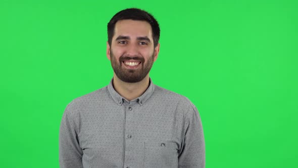 Portrait of Brunette Guy Is Laughing. Green Screen