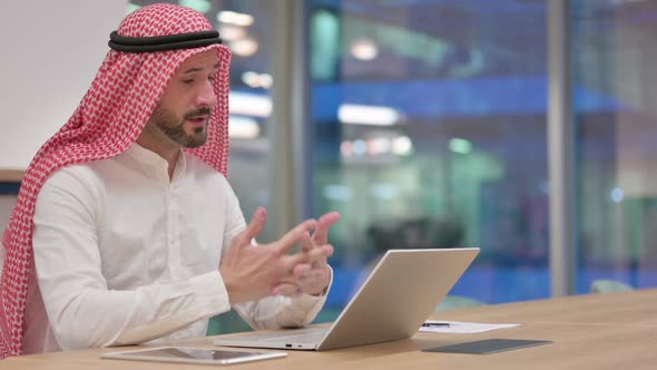 Cheerful Arab Businessman Doing Video Call on Laptop