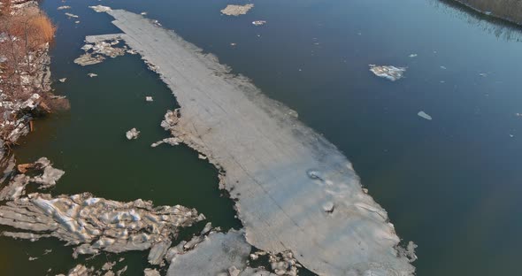 Landscape View on the Shore of the River Floating Ice Drifting Floes on the Frozen River